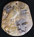 Phoenix or perhaps even a stylized crane, holding a ruyi in beak, also contains a shoe- curled toed, as well as lotus flowers, pods and a leaf that the bird is standing on.