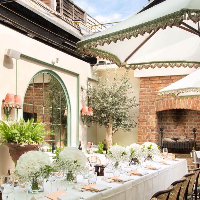Long table set for a wedding in the conservatory at daphne's